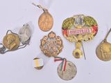 a lot of medals and medals on a white surface