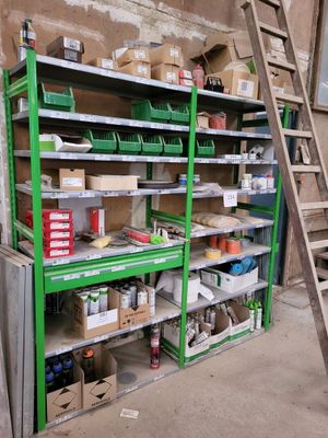 many shelves with various items on them in a room