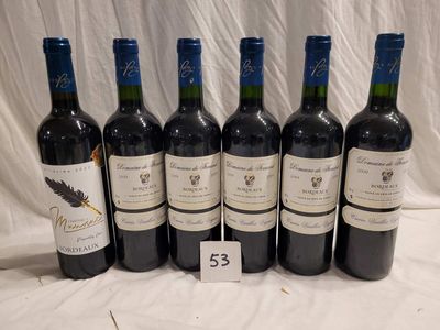 several bottles of wine are lined up on a table