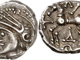 a close up of a silver coin with a face on it