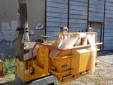 a yellow machine that is parked in front of a building