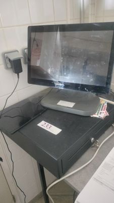 a computer monitor sitting on top of a desk next to a printer