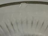 a glass bowl that has a long handle in it