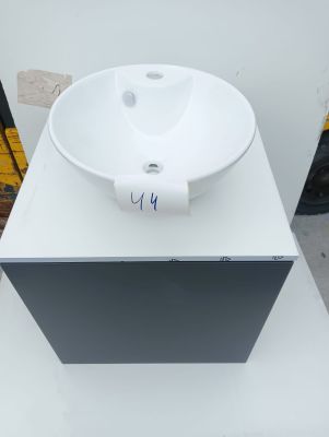 a white sink sitting on top of a white counter