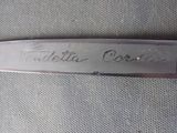 a close up of a knife with writing on it