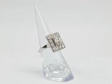 a close up of a diamond ring sitting on top of a clear cone