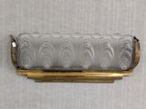 an image of a glass and brass wall sconce mounted on a wall
