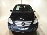 a black mercedes benz car parked in a garage