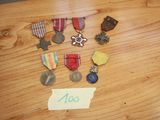 a lot of medals on a table with a note attached to it