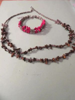 a necklace and bracelet that are on a table