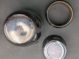 two empty jars sitting on a table next to each other
