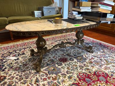 a marble top coffee table on a rug in a living room