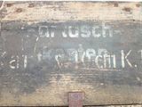 a sign on the side of an old wooden box