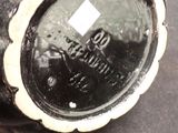 a close up of a black vase on a table