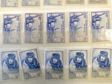 some old stamps are on display on a table in a glass case