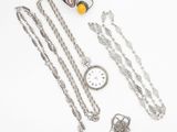 beaucoup de bijoux en argent sur une surface blanche