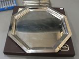 a lot of silver trays sitting on a table