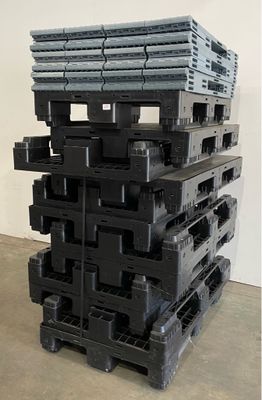 a stack of black plastic pallets stacked on top of each other