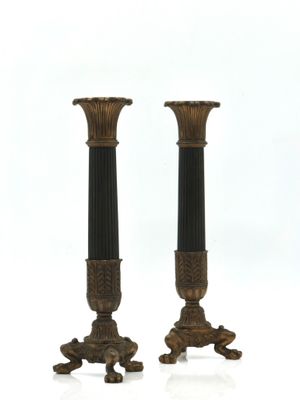 pair of antique bronze and black candlesticks on pedestals