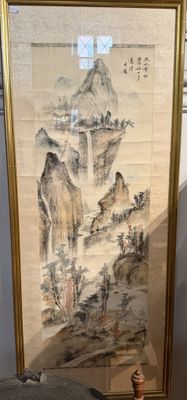 a picture of a painting hanging on a wall next to a vase