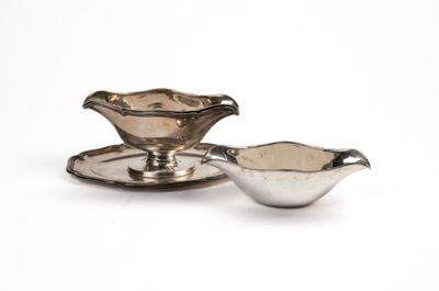 silver plated sauce boat and saucer on a white background