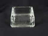 a clear glass box with a lid on a black background