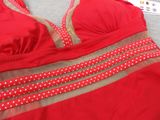 a close up of a red bra top with polka dots on it