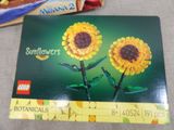 two lego sunflowers on the table next to a lego box