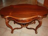 a wooden table with a wooden top on a tile floor