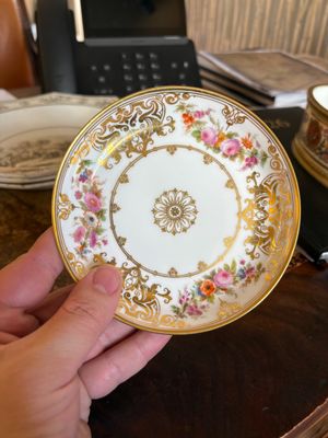 a person holding a plate on a table in a room