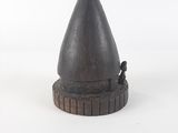 a small wooden object that is on a white surface