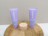 two tubes of skin care sitting on a wooden tray