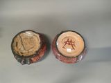 two bowls with designs on them sitting on a table
