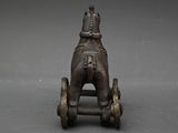 a toy horse that is sitting on top of a cart