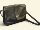 black leather cross body bag with shoulder strap on a white background
