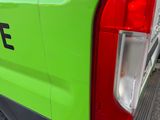 the back end of a green van parked on the side of the road
