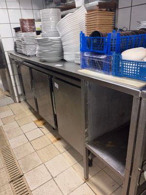 many plates and bowls on the counter in the kitchen