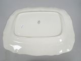 a white plate with a flower on it on a table