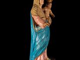 an image of a statue of the virgin mary holding a child