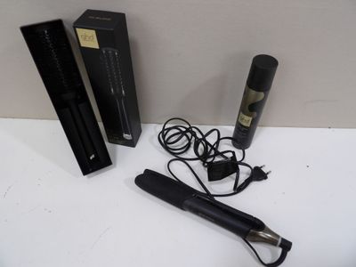 a hair dryer and a box of hair products on a table