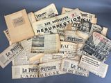 several newspapers are piled on top of each other on a blue surface