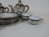 a lot of plates and cups that are sitting on a table