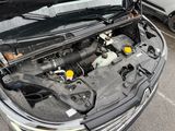 the engine of a car with its hood open in a parking lot