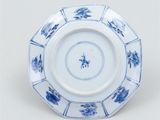 a blue and white plate with blue flowers on it