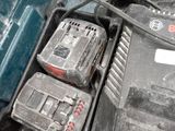 two power tools in a tool box that is dirty