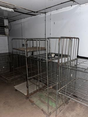 many metal cages in a room with no one on them