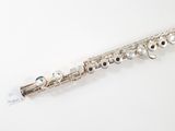 a close up of a flute on a white surface with a label