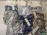 a group of men ' s shirts in plastic bags sitting on top of a table