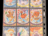 many pokemon cards on a binder on a black background