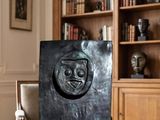 a black sculpture on a wooden table in a living room